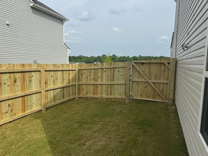 A well-installed wooden fence in a suburban backyard in Rock Hill, SC